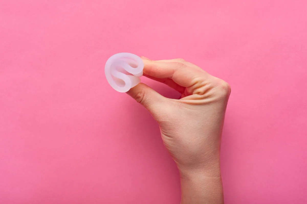 Manos sujetando una copa menstrual de silicona