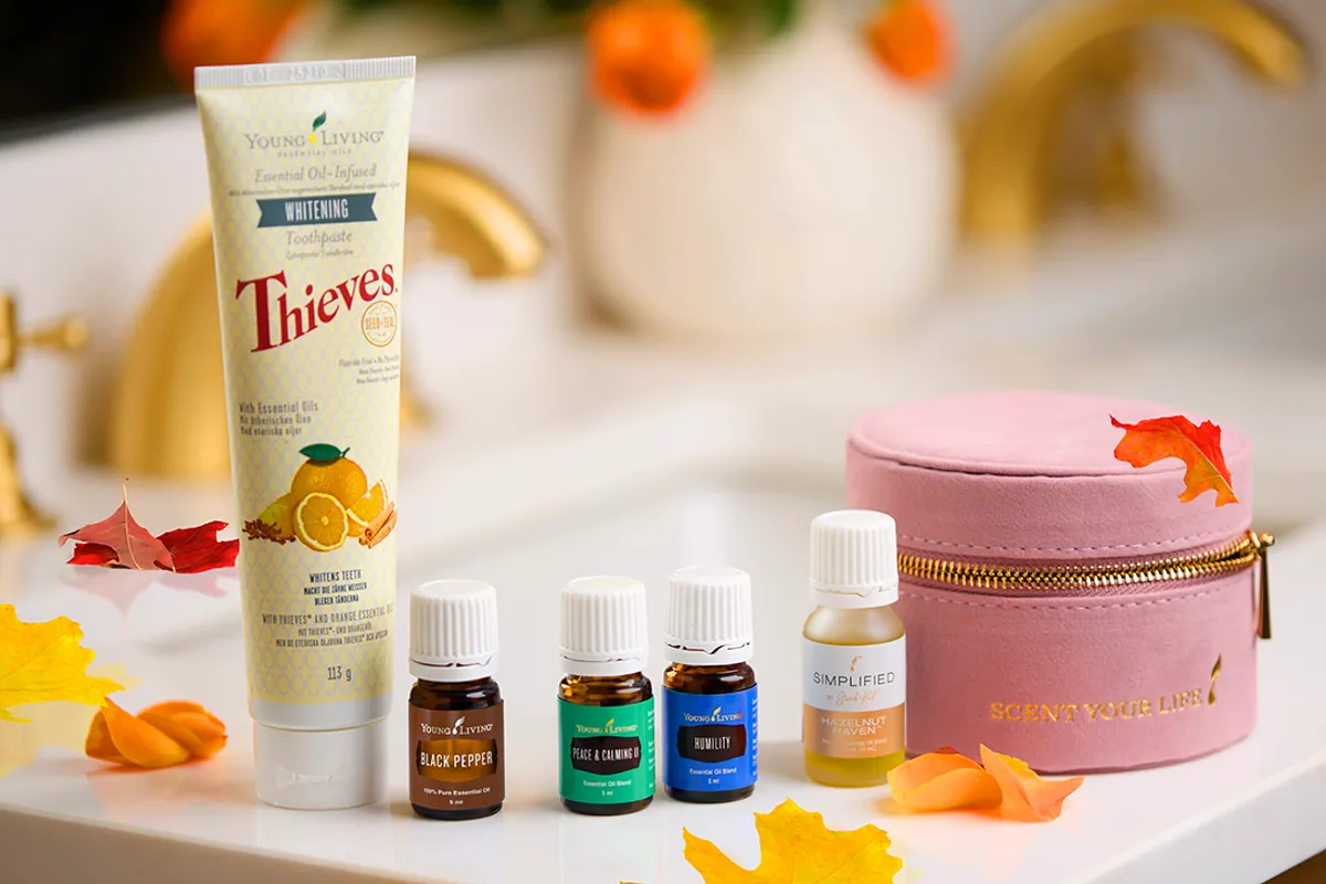 Pasta de dientes Thieves y varios aceites esenciales de Young Living sobre un lavabo