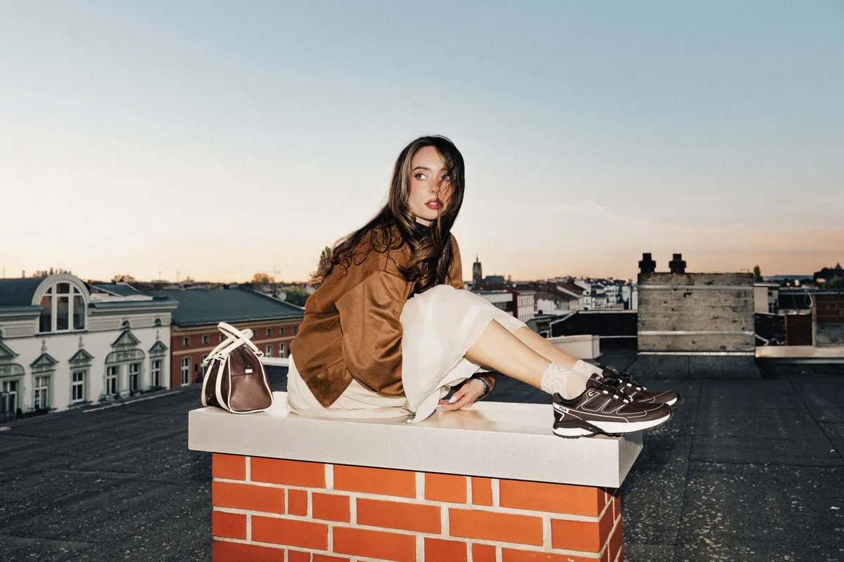 Dos chicas con sneakers FILA y bolso en la calle, estilo urbano de otoño