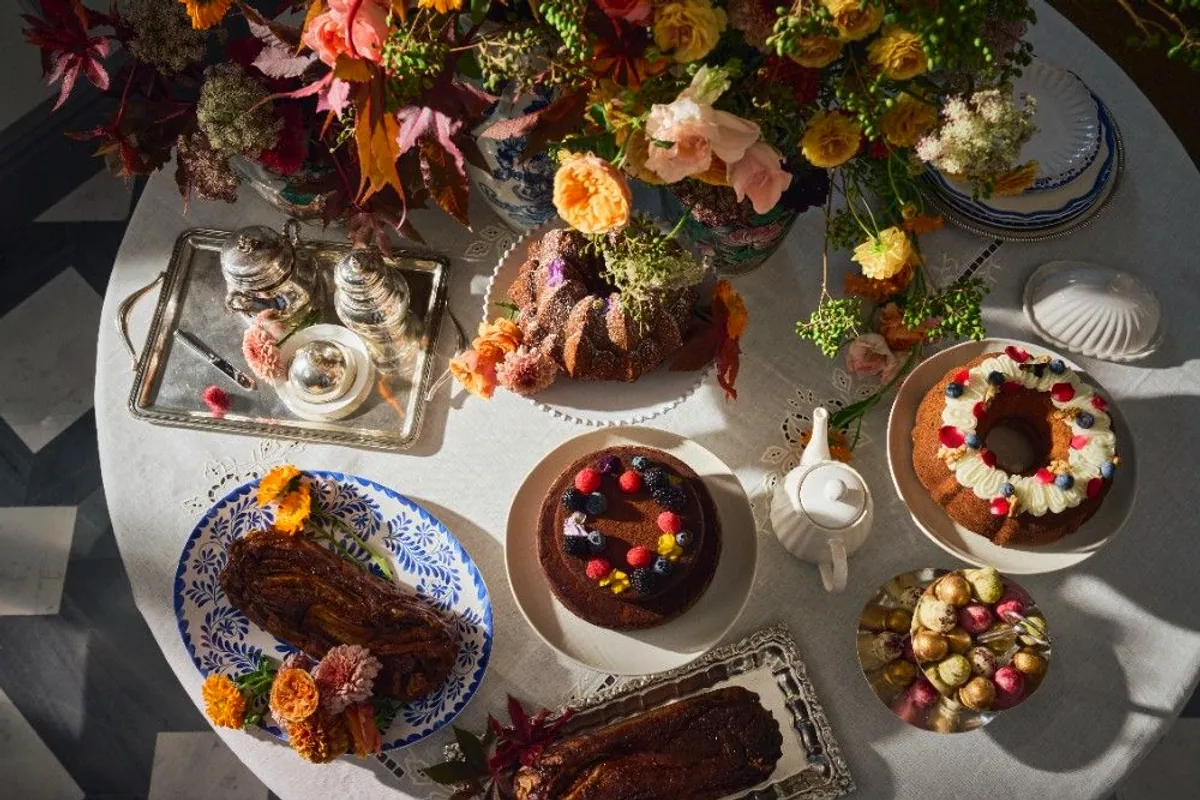 Mesa de dulces con bizcochos, flores de otoño y vajilla de porcelana