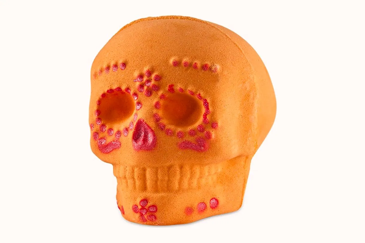 Bomba de baño Calaverita de Lush, calavera naranja decorada en rosa